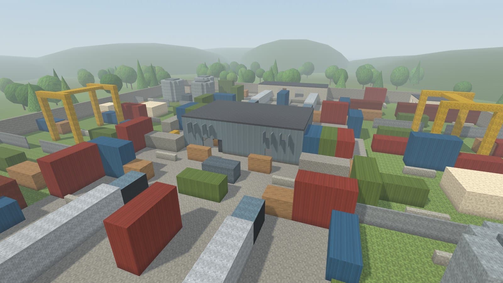 A container yard with yellow gantry cranes around a grey warehouse.